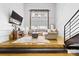 Modern living room featuring exposed brick, tall windows, comfortable seating, and warm lighting at 925 Westmere Ave, Charlotte, NC 28208