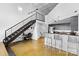 Open concept living space with stairs and an adjacent kitchen featuring stainless steel appliances at 925 Westmere Ave, Charlotte, NC 28208