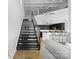 Open living space with staircase, adjacent kitchen and industrial style ceiling at 925 Westmere Ave, Charlotte, NC 28208