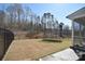 Spacious fenced backyard with a screened porch and trampoline near a wooded area at 966 Scotch Meadows Loop, Monroe, NC 28110
