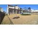 Large backyard with a screened porch, trampoline, and black metal fence at 966 Scotch Meadows Loop, Monroe, NC 28110