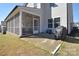 Spacious backyard featuring a screened-in porch, patio area, and well-maintained lawn at 966 Scotch Meadows Loop, Monroe, NC 28110