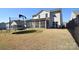Exterior view of a backyard featuring a trampoline, screened porch, and black fence at 966 Scotch Meadows Loop, Monroe, NC 28110