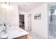 Modern bathroom with double sinks, tiled shower, and walk-in closet access at 966 Scotch Meadows Loop, Monroe, NC 28110