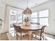 Inviting dining area with round wooden table, woven light fixture, and natural light at 966 Scotch Meadows Loop, Monroe, NC 28110