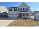 Charming two-story home with a well-manicured lawn, attached garage and inviting front porch at 966 Scotch Meadows Loop, Monroe, NC 28110