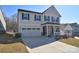 Charming two-story home with an attached garage and inviting front porch at 966 Scotch Meadows Loop, Monroe, NC 28110