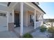 Inviting front porch with classic columns, a rocking chair, and decorative landscaping at 966 Scotch Meadows Loop, Monroe, NC 28110