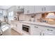 Well-appointed kitchen with white cabinets, subway tile backsplash, and stainless steel microwave at 966 Scotch Meadows Loop, Monroe, NC 28110