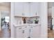 Bright kitchen area with white cabinets and modern countertop appliances at 966 Scotch Meadows Loop, Monroe, NC 28110