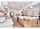 Bright, modern kitchen features a large island, white cabinetry, and pendant lighting at 966 Scotch Meadows Loop, Monroe, NC 28110