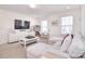 Living room with white furniture, carpet, a TV and access to a desk area at 966 Scotch Meadows Loop, Monroe, NC 28110