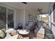 Relaxing covered porch area featuring wicker furniture, ceiling fans and outdoor dining at 966 Scotch Meadows Loop, Monroe, NC 28110