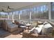 Comfortable covered porch featuring stylish wicker furniture and ceiling fans for outdoor relaxation at 966 Scotch Meadows Loop, Monroe, NC 28110