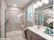 Bathroom showcasing a walk-in shower with tiled walls and glass door, and vanity with sink at 9842 Quercus Ln, Huntersville, NC 28078