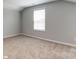 Unfurnished bedroom with carpeted floors and a window offering natural light at 9842 Quercus Ln, Huntersville, NC 28078