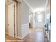 Elegant hallway with pristine trim work and a view of the well-lit front entrance at 9842 Quercus Ln, Huntersville, NC 28078