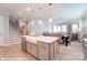 Bright kitchen featuring a large island with a farmhouse sink and an open view to the living area at 9842 Quercus Ln, Huntersville, NC 28078