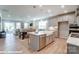 Open-concept kitchen featuring a large island, stainless steel appliances, and seamless flow to living area at 9842 Quercus Ln, Huntersville, NC 28078