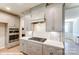 This kitchen boasts stainless steel appliances, stylish gray cabinets, and a gas range stove under a modern hood vent at 9842 Quercus Ln, Huntersville, NC 28078