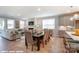 Open-concept living space with dining area, fireplace, and large windows offering lots of natural light at 9842 Quercus Ln, Huntersville, NC 28078