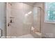 Modern walk-in shower with marble-look tiles, glass door, and convenient built-in bench at 9842 Quercus Ln, Huntersville, NC 28078