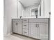 Bright bathroom featuring a modern vanity with gray cabinets and a large mirror at 9934 Cask Way, Huntersville, NC 28078