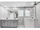 A modern bathroom featuring a double vanity with gray cabinets and a large walk-in shower with marble tiling at 9934 Cask Way, Huntersville, NC 28078