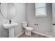 Clean and modern half-bathroom with pedestal sink at 9934 Cask Way, Huntersville, NC 28078