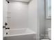 Clean and bright bathroom featuring a white tub with subway tile surround and black fixtures at 9934 Cask Way, Huntersville, NC 28078