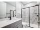 Modern bathroom with sleek gray vanity and glass enclosed shower with marble tile at 9934 Cask Way, Huntersville, NC 28078