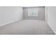Bedroom with neutral carpeting, double hung windows, and white trim at 9934 Cask Way, Huntersville, NC 28078