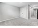 A serene bedroom with soft carpeting, neutral walls, and a double door closet at 9934 Cask Way, Huntersville, NC 28078