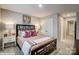 Inviting bedroom features a stylish black panel bed, soft carpet, and soothing gray wall paint at 9934 Cask Way, Huntersville, NC 28078