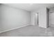 A light-filled bedroom with neutral carpeting, white doors, and ample space at 9934 Cask Way, Huntersville, NC 28078