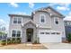 Charming two-story home featuring light gray siding, stone accents, and a two-car garage at 9934 Cask Way, Huntersville, NC 28078
