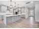 Spacious kitchen features an island with pendant lighting, stainless appliances and light gray cabinetry at 9934 Cask Way, Huntersville, NC 28078
