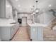 Spacious kitchen featuring gray cabinets, stainless steel appliances, island with sink, and modern pendant lighting at 9934 Cask Way, Huntersville, NC 28078