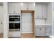 Light gray cabinets with stainless appliances, including double ovens and a space for the refrigerator at 9934 Cask Way, Huntersville, NC 28078