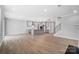 Bright and open living space with hardwood floors, kitchen island, and staircase at 9934 Cask Way, Huntersville, NC 28078