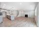 Open-concept living room features a cozy fireplace and seamlessly connects to the gourmet kitchen at 9934 Cask Way, Huntersville, NC 28078