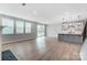 Open living area with hardwood floors, large windows, and a modern kitchen island at 9934 Cask Way, Huntersville, NC 28078