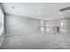 Bright upstairs loft area features neutral carpet and wrought iron staircase at 9934 Cask Way, Huntersville, NC 28078
