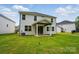Home backyard with a green lawn and a covered patio at 9957 Cask Way, Huntersville, NC 28078