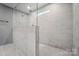 Modern bathroom featuring marble-tiled walk-in shower, providing a spa-like experience within the home at 9957 Cask Way, Huntersville, NC 28078