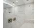 Luxurious bathroom featuring a marble-tiled shower with bench and dual shower heads, offering a spa-like experience at 9957 Cask Way, Huntersville, NC 28078