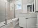 Bathroom with tiled shower, window, toilet, and vanity at 9957 Cask Way, Huntersville, NC 28078