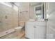 Modern bathroom with marble tile, glass shower, vanity and sink at 9957 Cask Way, Huntersville, NC 28078