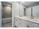 Stylish bathroom with a double vanity, contemporary fixtures, and a view into the bathtub and shower at 9957 Cask Way, Huntersville, NC 28078