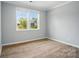 Bright bedroom with large window and hardwood floors at 9957 Cask Way, Huntersville, NC 28078